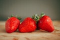 Fresh strawberry on a dark wood background, close up of big strawberry on wood