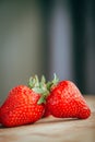 Fresh strawberry on a dark wood background, close up of big strawberry on wood