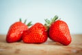 Fresh strawberry on a dark wood background, close up of big strawberry on wood