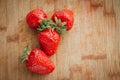 Fresh strawberry on a dark wood background, close up of big strawberry on wood