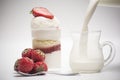 Fresh strawberry and dessert. Pour milk inside the glass Royalty Free Stock Photo