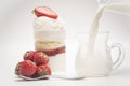 Fresh strawberry and dessert. Pour milk inside the glass Royalty Free Stock Photo