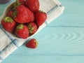 fresh strawberry dish towel on a blue wooden background Royalty Free Stock Photo