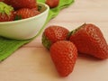 Fresh strawberry dish towel on a pink wooden background