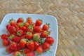 Fresh strawberry dish on woven bamboo floor Royalty Free Stock Photo