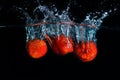 fresh strawberry dropped into water with splash on black backgrounds Royalty Free Stock Photo