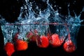 fresh strawberry dropped into water with splash on black backgrounds Royalty Free Stock Photo