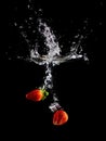 Fresh strawberry making splash in water. Royalty Free Stock Photo