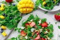 Fresh strawberry, mango, blueberrie salad with feta cheese, arugula on white plate Royalty Free Stock Photo