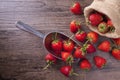 Fresh strawberry in metal ladle on wood table, top view image. Royalty Free Stock Photo