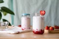 Fresh Strawberry Milk in a jar, red strawberry layer at the bottom, white milk layer on top and garnish with heart sharp Royalty Free Stock Photo