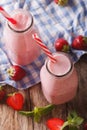 Fresh strawberry milkshake in glass bottles close-up on the table. vertical top view Royalty Free Stock Photo