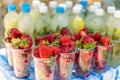 Selective focus on fresh strawberry and background from mojito or lemonade with mint. Summer time beach food and drink Royalty Free Stock Photo