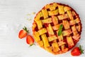 Fresh strawberry pie or tart with berries on white