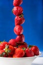 Fresh strawberry in plate on blue background Royalty Free Stock Photo