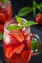 Fresh strawberry smoothie. Fresh summer cocktail with strawberries and ice cubes on a dark background on a black wooden table Royalty Free Stock Photo