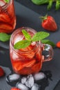 Fresh strawberry smoothie. Fresh summer cocktail with strawberries and ice cubes on a dark background on a black wooden table Royalty Free Stock Photo