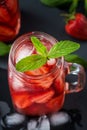 Fresh strawberry smoothie. Fresh summer cocktail with strawberries and ice cubes on a dark background on a black wooden table Royalty Free Stock Photo