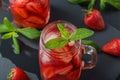 Fresh strawberry smoothie. Fresh summer cocktail with strawberries and ice cubes on a dark background on a black wooden table Royalty Free Stock Photo