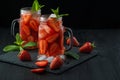 Fresh strawberry smoothie. Fresh summer cocktail with strawberries and ice cubes on a dark background on a black wooden table Royalty Free Stock Photo