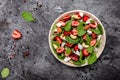 Fresh strawberry spinach salad with feta cheese, nuts and feta cheese, balsamic vinegar. Delicious balanced food concept. banner, Royalty Free Stock Photo