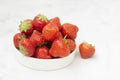 Fresh strawberry on white background in white bowl, fresh fruits for breakfast or healthy food snack, copy space