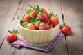 Fresh strawberry on wood plate, red tasty fruit on kitchen table Royalty Free Stock Photo