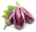 Fresh striped aubergines or eggplants with leaf and slices isolated on white background