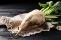 Fresh sugar beet with leaves on black wooden table, closeup Royalty Free Stock Photo