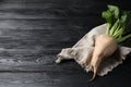 Fresh sugar beet with leaves on black wooden table. Space for text Royalty Free Stock Photo