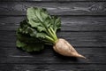 Fresh sugar beet with leaves on black wooden table, top view Royalty Free Stock Photo