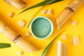 Fresh sugar cane juice and cane on a yellow background. Top view