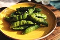 Fresh sugar snap peas on yellow plate Royalty Free Stock Photo