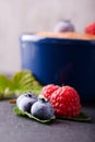 Fresh summer berries on slate stone with creamy dessert Royalty Free Stock Photo