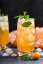 Fresh summer cocktail with orange juice and ice cubes. Glass of orange soda drink on dark background Royalty Free Stock Photo