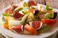 Fresh summer fruit salad with fig, peach, melon, kiwi and orange Royalty Free Stock Photo