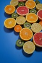 Fresh summer fruits on blue background. Flat lay. Tropical summer mix grapefruit, orange, mandarin, kiwi, lemon Royalty Free Stock Photo