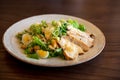 Fresh summer salad Ceasar with eggs, lettuce, chicken and parmesan cheese on white plate on wooden background; healthy concept; si Royalty Free Stock Photo