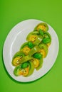 Fresh summer salad from green heirloom tomato Kiwi, fresh basil leaves and extra virgin olive oil Royalty Free Stock Photo