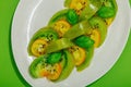 Fresh summer salad from green heirloom tomato Kiwi, fresh basil leaves and extra virgin olive oil Royalty Free Stock Photo