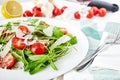 Fresh, summer salad with halves of cherry tomatoes and arugula Royalty Free Stock Photo