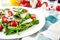 Fresh, summer salad with halves of cherry tomatoes and arugula Royalty Free Stock Photo