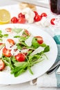 Fresh, summer salad with halves of cherry tomatoes and arugula Royalty Free Stock Photo