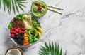 Fresh summer salad with quinoa, peach, micro greens, avocado, berries, coconut, melon on light marble background with tropical Royalty Free Stock Photo