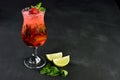 Fresh summer strawberry mojito drink with ice, served on black wood Royalty Free Stock Photo