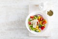 Fresh summer vegetable salad with lettuce, tomato, cucumber, bell pepper, onion and feta cheese Royalty Free Stock Photo