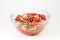 Fresh summer vegetable salad with tomatoes, cucumber, green pepper, red onion rings and olives in a glass bowl Royalty Free Stock Photo