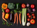 Fresh summer vegetables flatlay on black background. Tomatoes, parsley, broccoli, carrot, leek, celery onion, squash, zucchini, Royalty Free Stock Photo