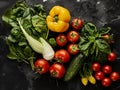 Fresh summer vegetables flatlay on green background. Salad romano, tomatoes, yellow pepper, basil, arugola, cucumber