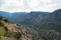 Fresh surrounding view of Parnassus limestone mountain valley, shades of green olive groves and other trees with sky background